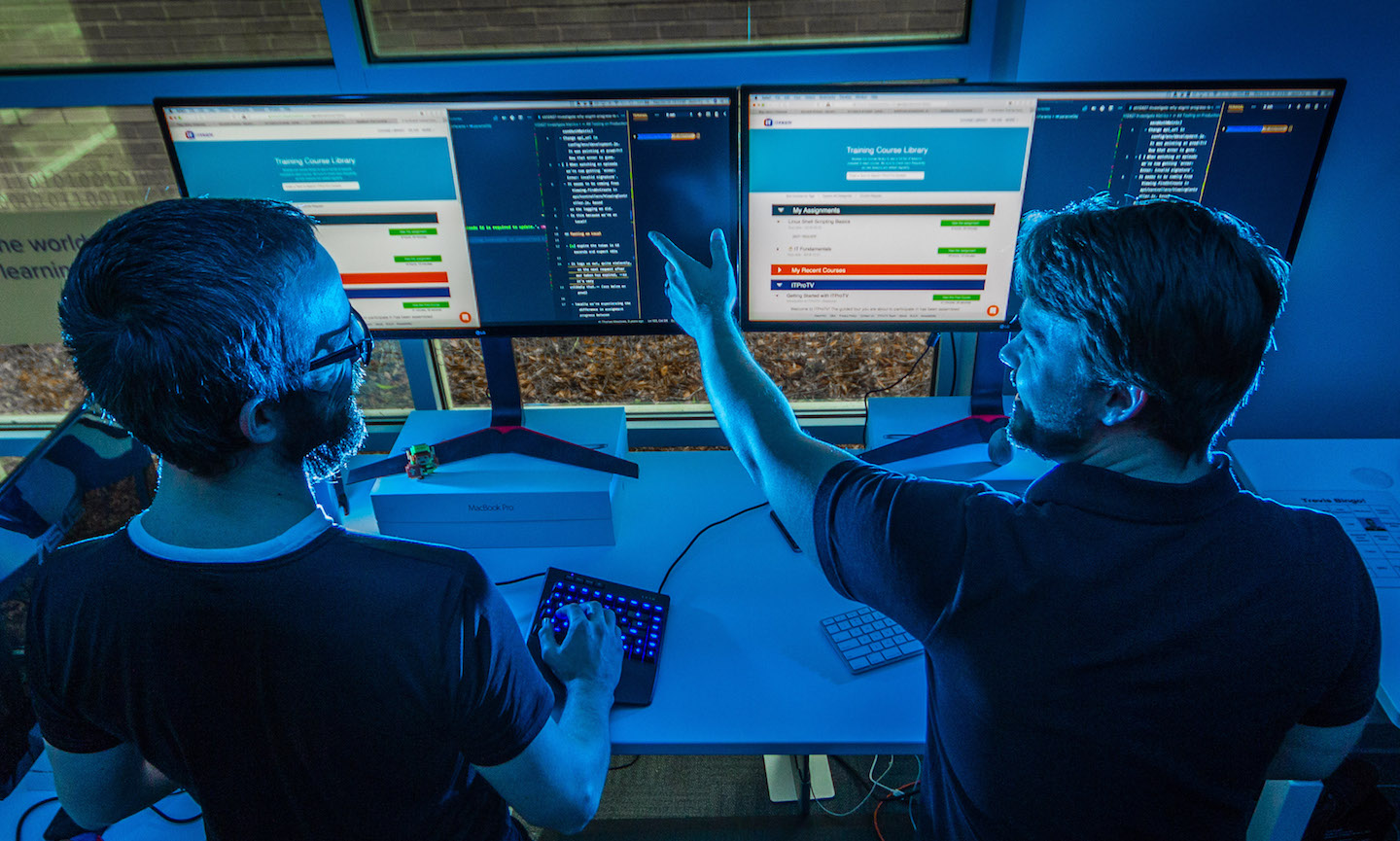 A photo of two people working at a pairing station